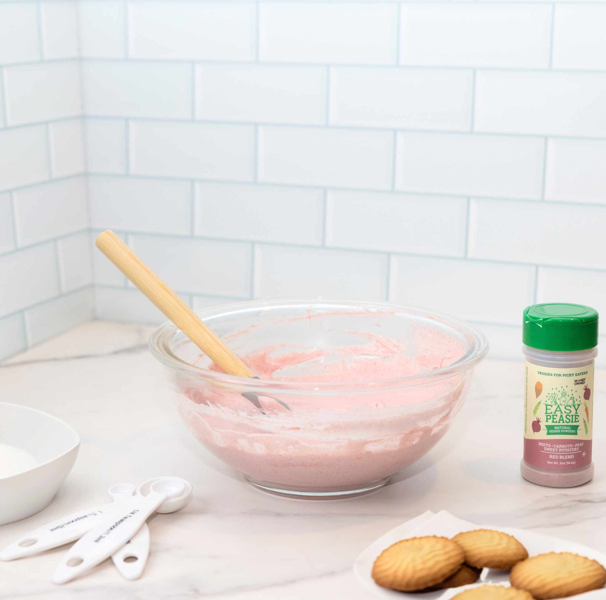 Easy Peasie Red Blend veggie powder being used to in cooking frosting