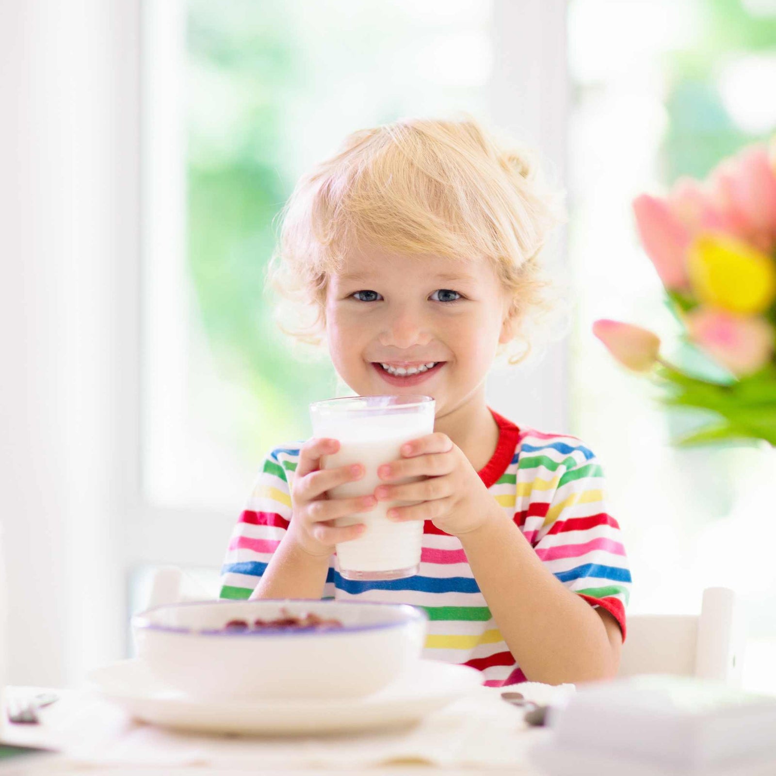 kid drinking a glass of milk