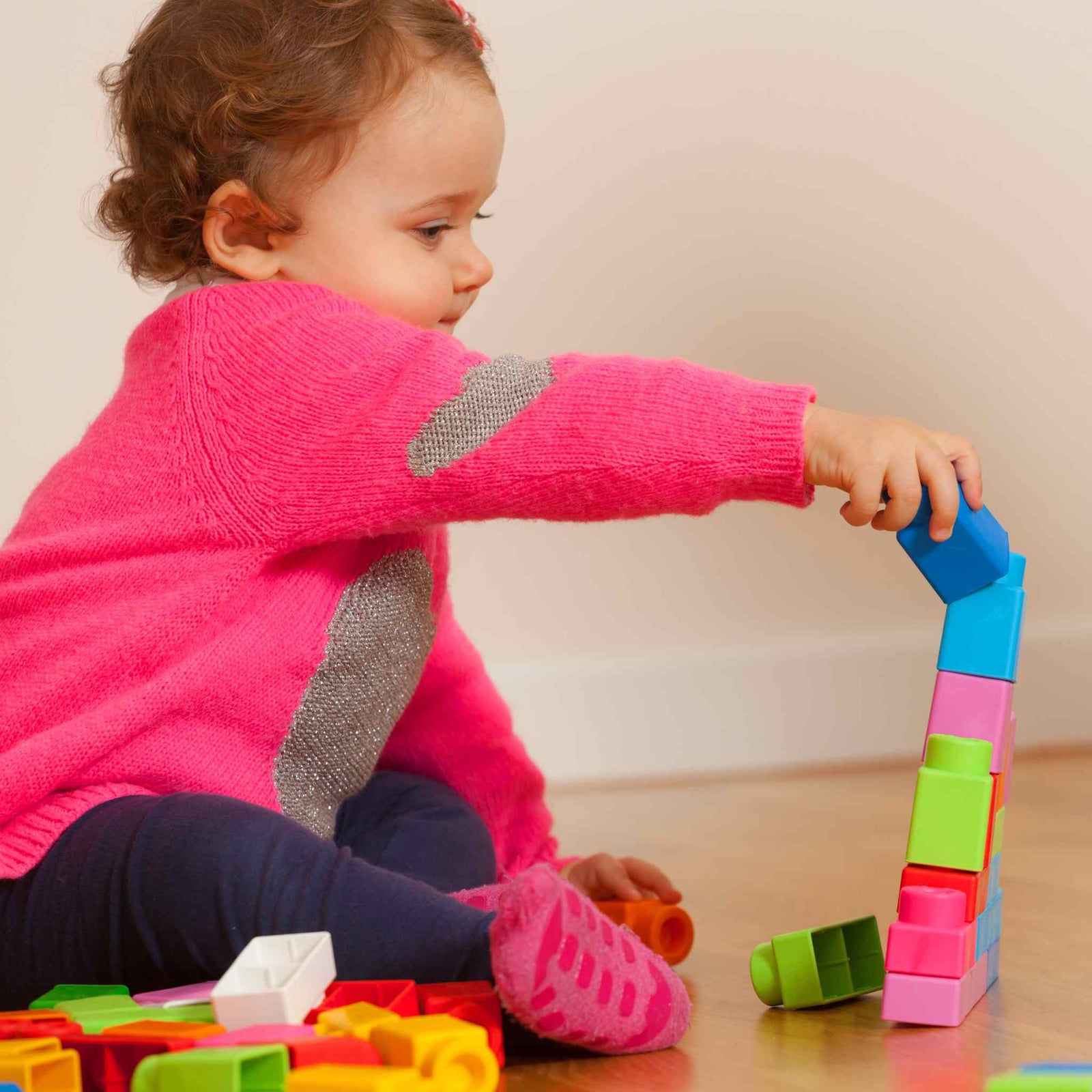 child playing with colorful building blocks