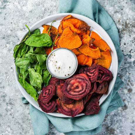Colorful array of nutritious vegetables including sweet potatoes, spinach and beets 