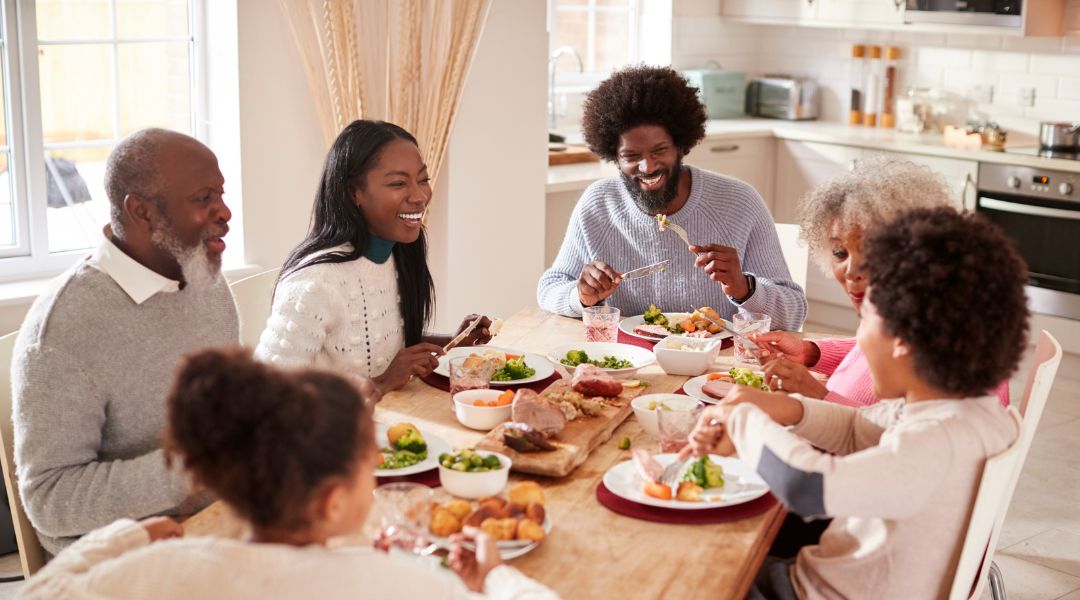 Multi-generational family gathered around dinner table