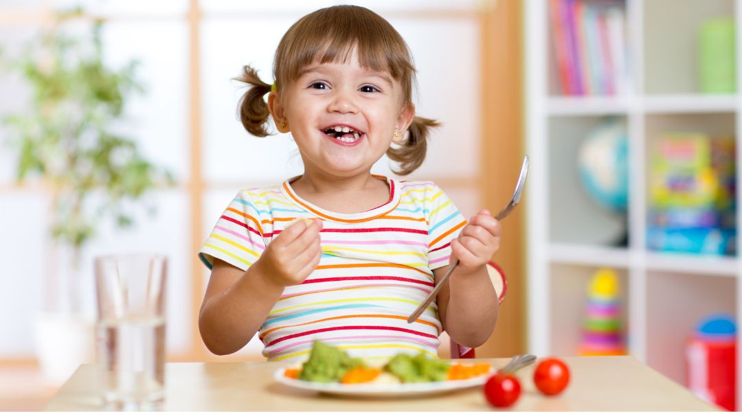 happy healthy child eating vegetables