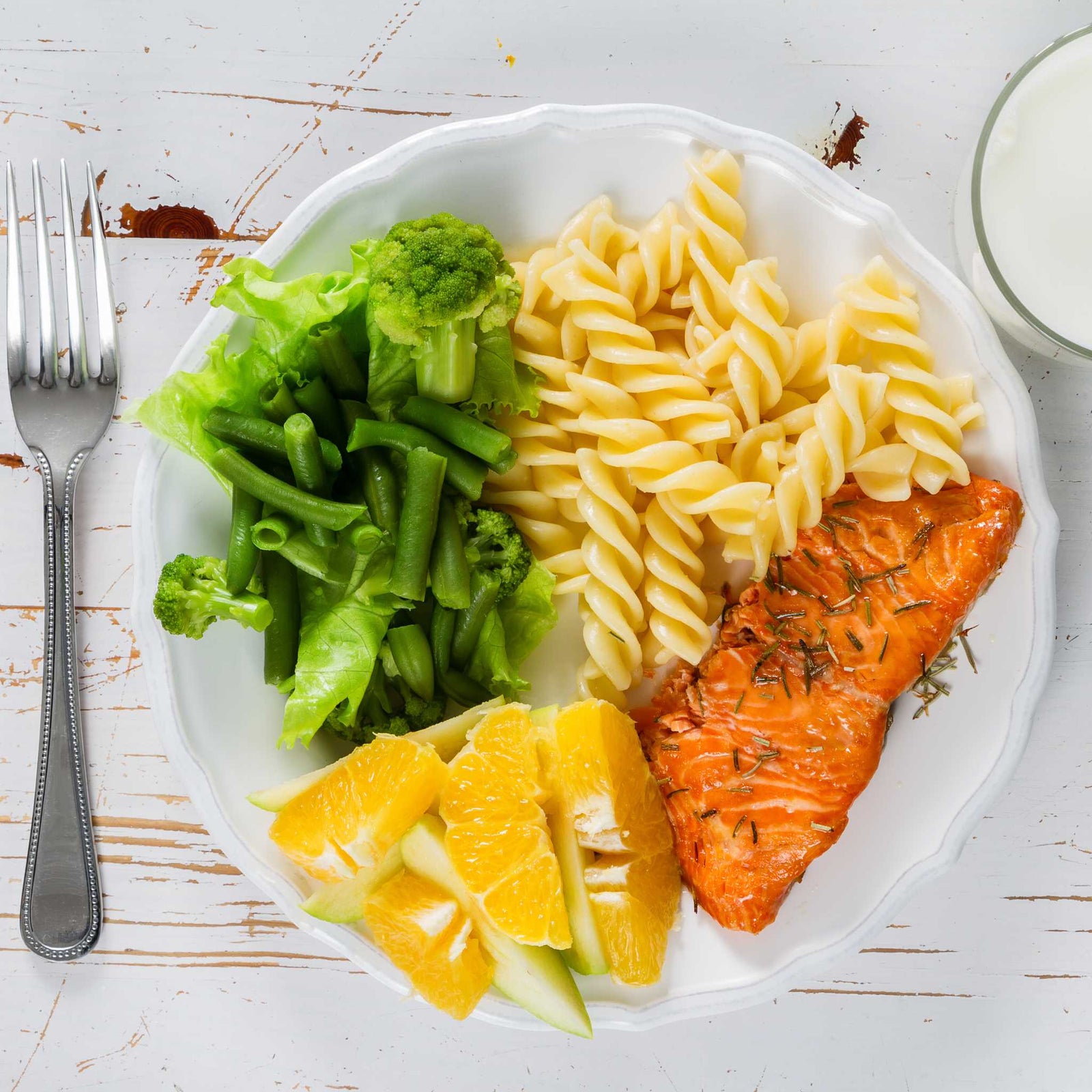 plate of salmon, pasta, and vegetables with different food textures