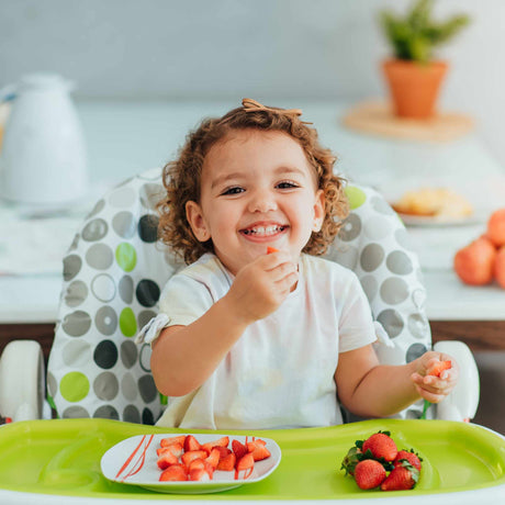 happy kid eating at the table