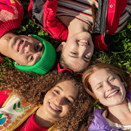 kids laying on their backs, smiling