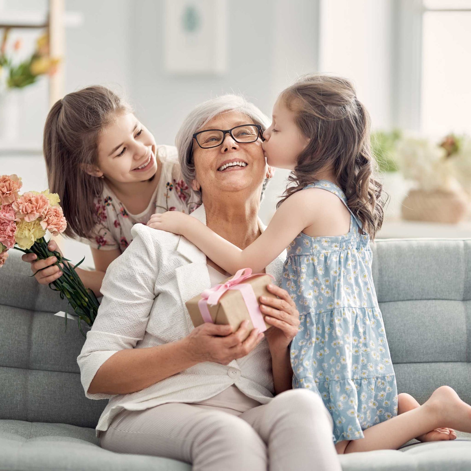 Children giving grandma kisses and hugs