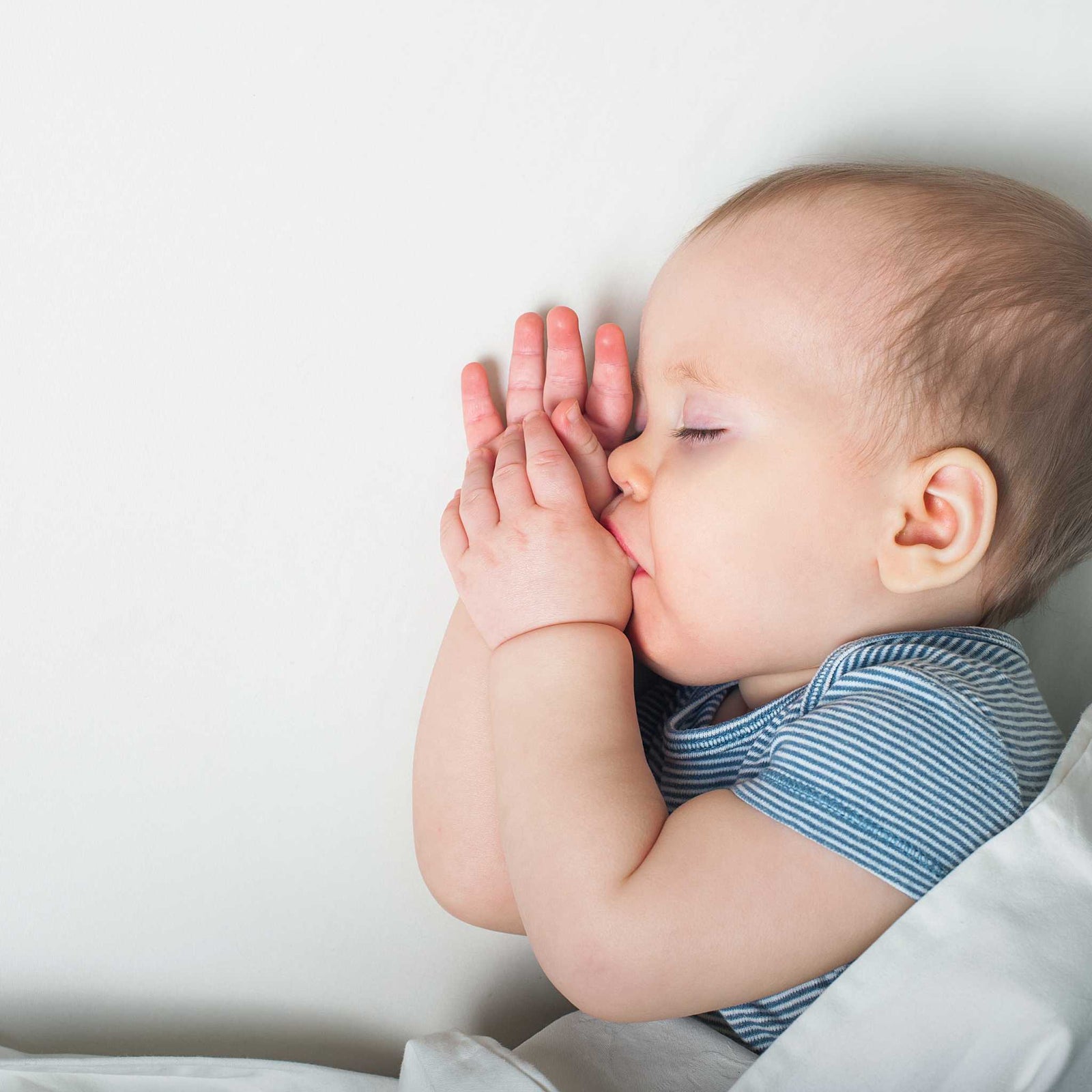 baby sleeping and sucking thumb