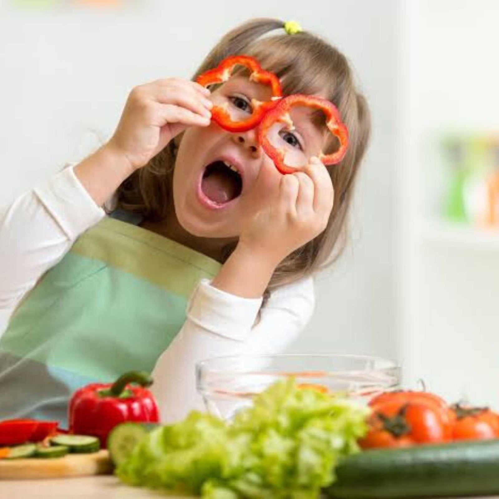 girl playing with creative vegetable cutouts