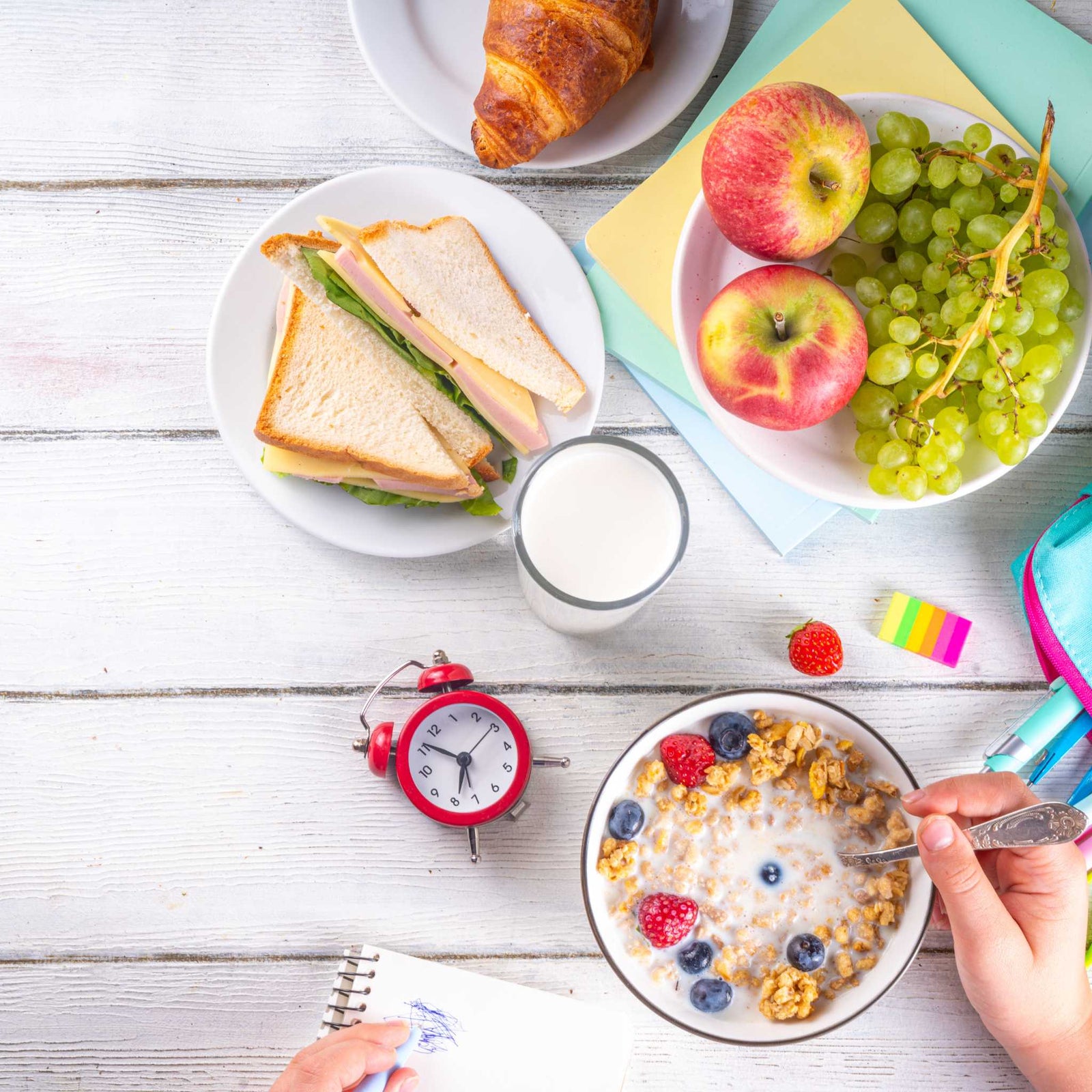 table full of breakfast foods and a clock