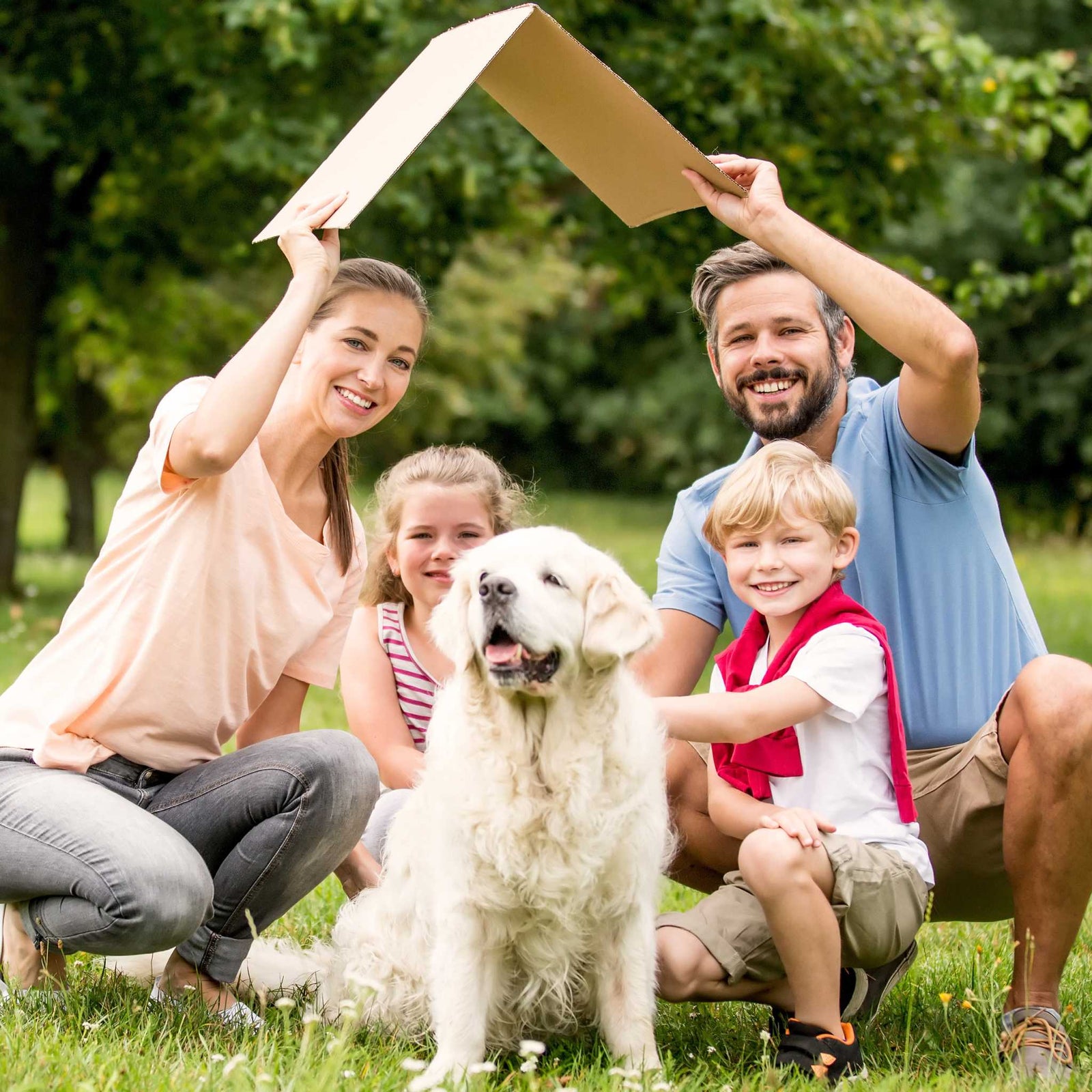 outdoors family portrait with mom, dad, two kids, and dog