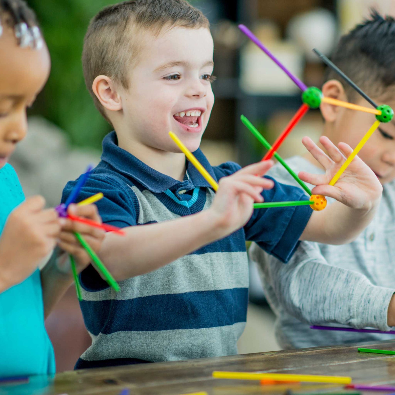 kids playing with building sticks