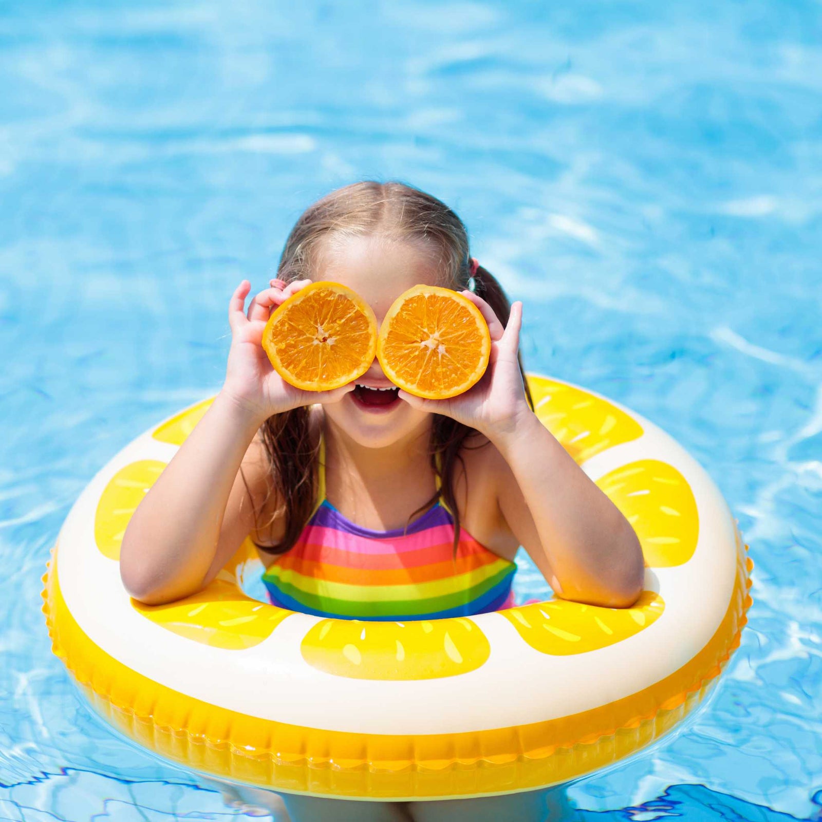 girl in flotation donut in pool