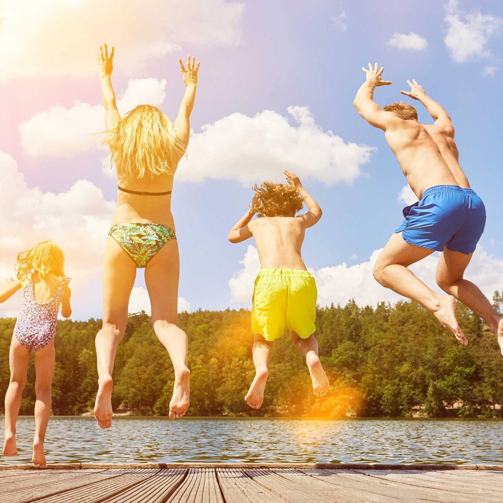 kids jumping into a lake