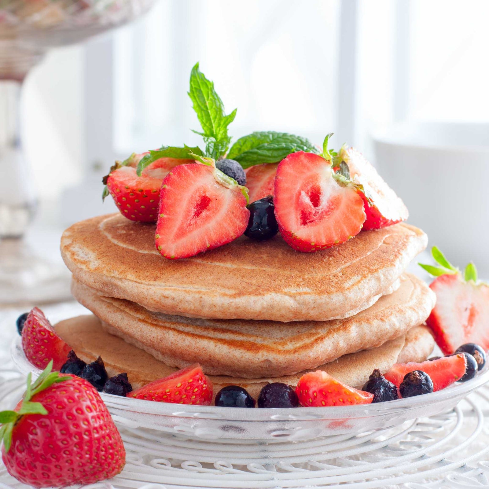 stack of pancakes topped with berries