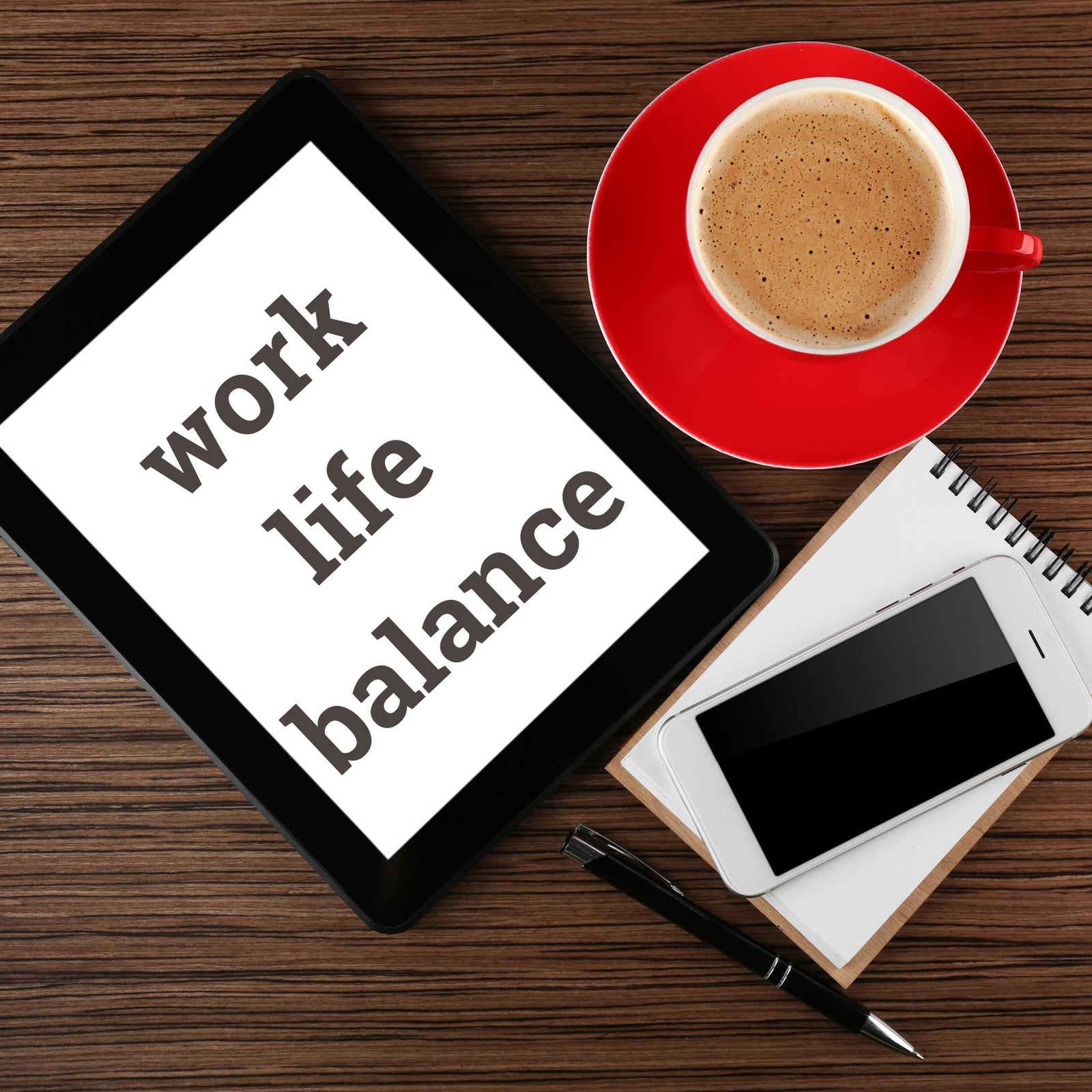 Work Life Balance sign with notepad and cup of coffee