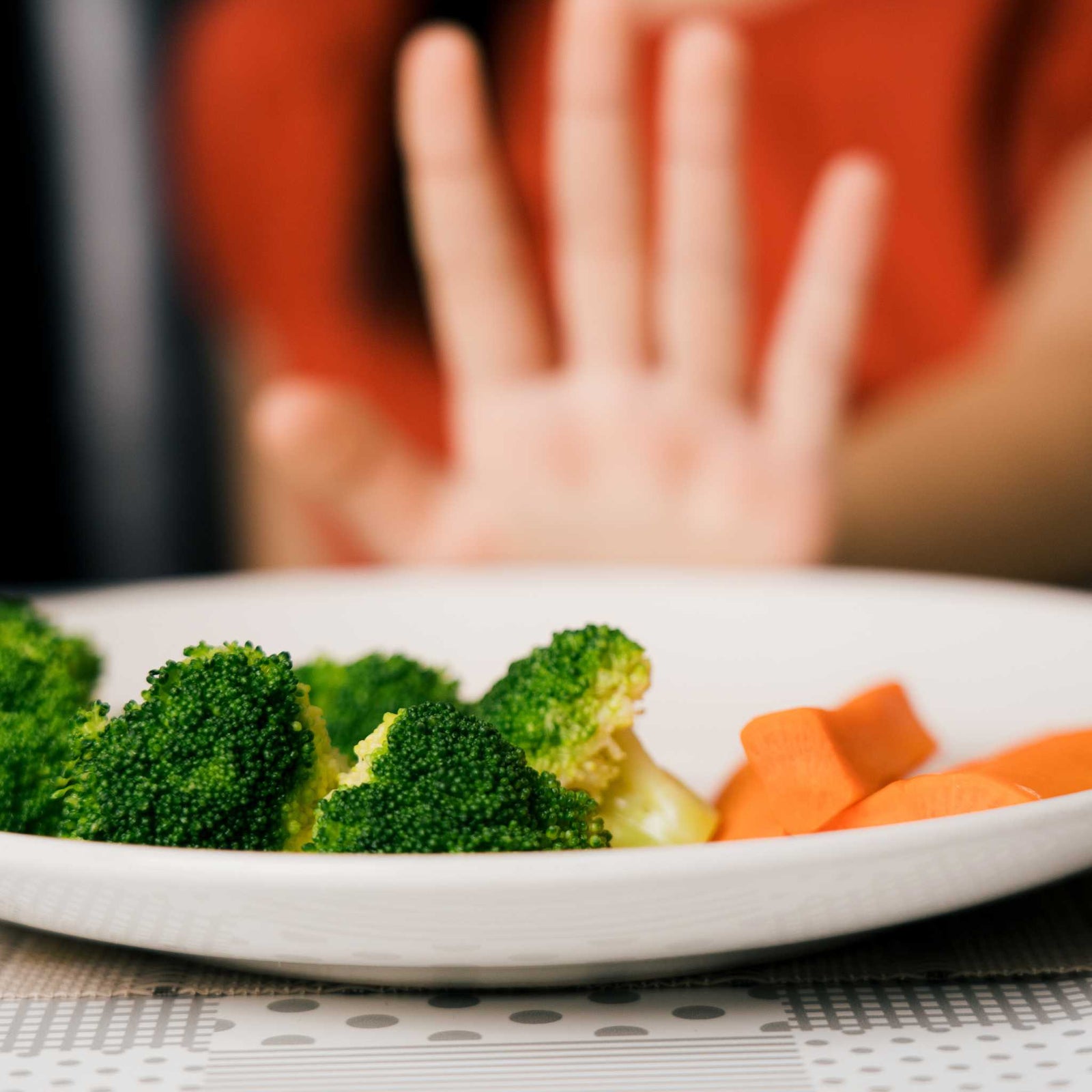 kid pushing away vegetables