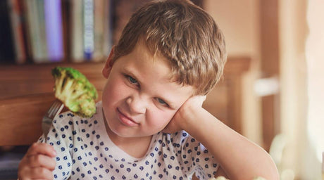 upset kid not eating broccoli