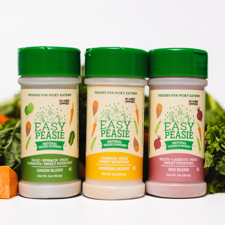 Three Easy Peasie product bottles with green lids on a white background with vegetables.