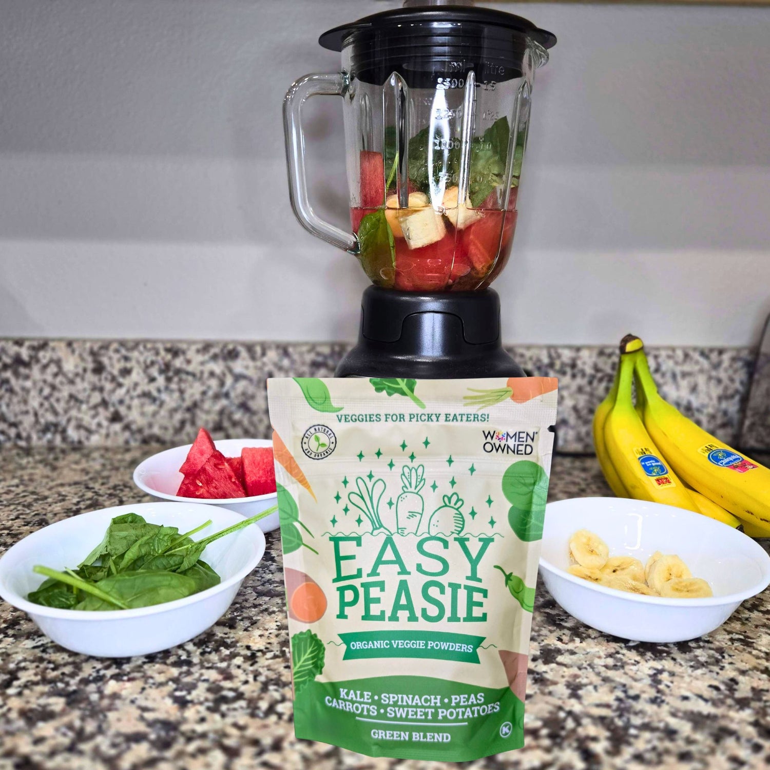 photo of Easy Peasie Veggie Powder Green Blend in front of smoothie ingredients and blender