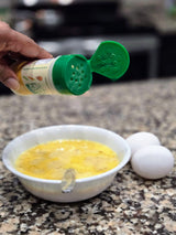 Easy Peasie veggie powder Original Blend being sprinkled into scrambled eggs