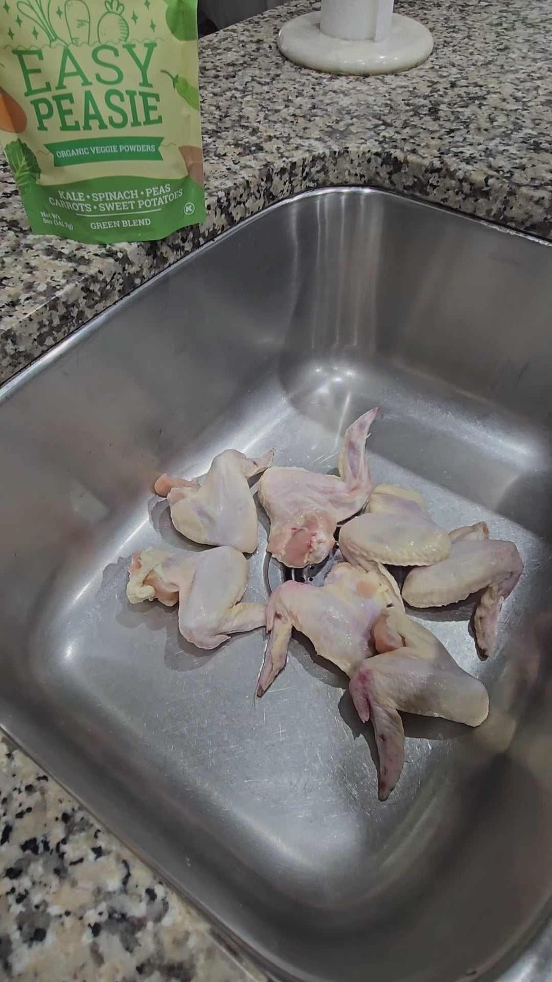 video showing Easy Peasie veggie powder Green Blend being sprinkled onto chicken wings (like seasoning)